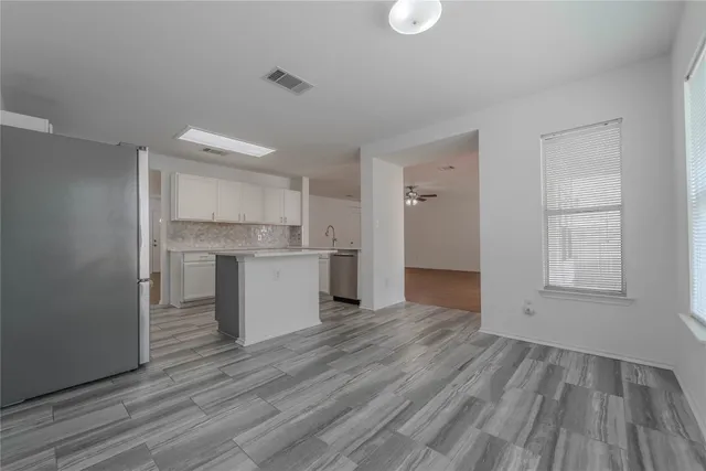 a view of kitchen and wooden floor