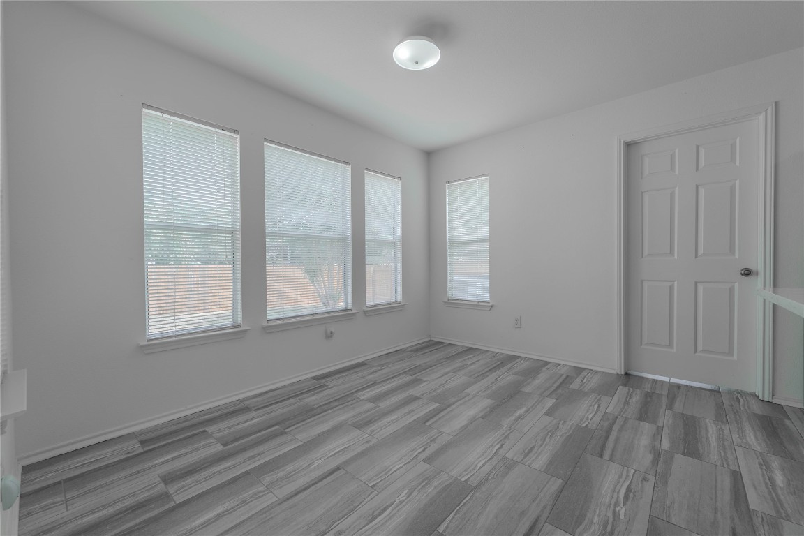 2000 Elk Ridge Cove Round Rock, TX 78665 - Photo 8 of 27 an empty room with wooden floor and windows