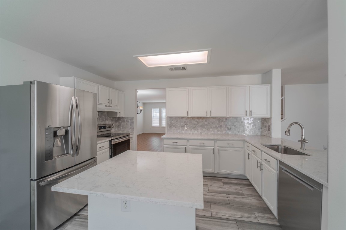 2000 Elk Ridge Cove Round Rock, TX 78665 - Photo 9 of 27 a kitchen with stainless steel appliances a refrigerator sink and microwave