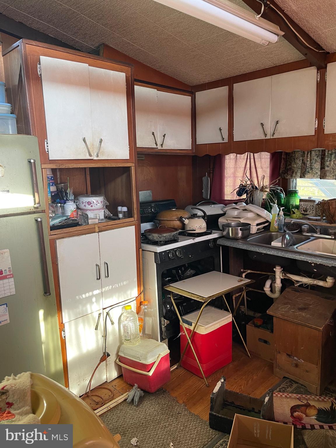 12173 Laurel Road Mardela Springs, MD 21837 - Photo 9 of 11 a kitchen with a stove and a microwave