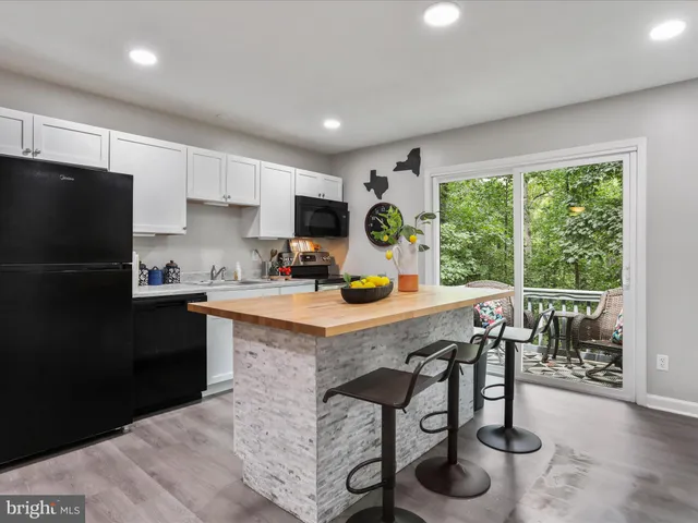a kitchen with stainless steel appliances granite countertop a stove refrigerator sink and cabinets