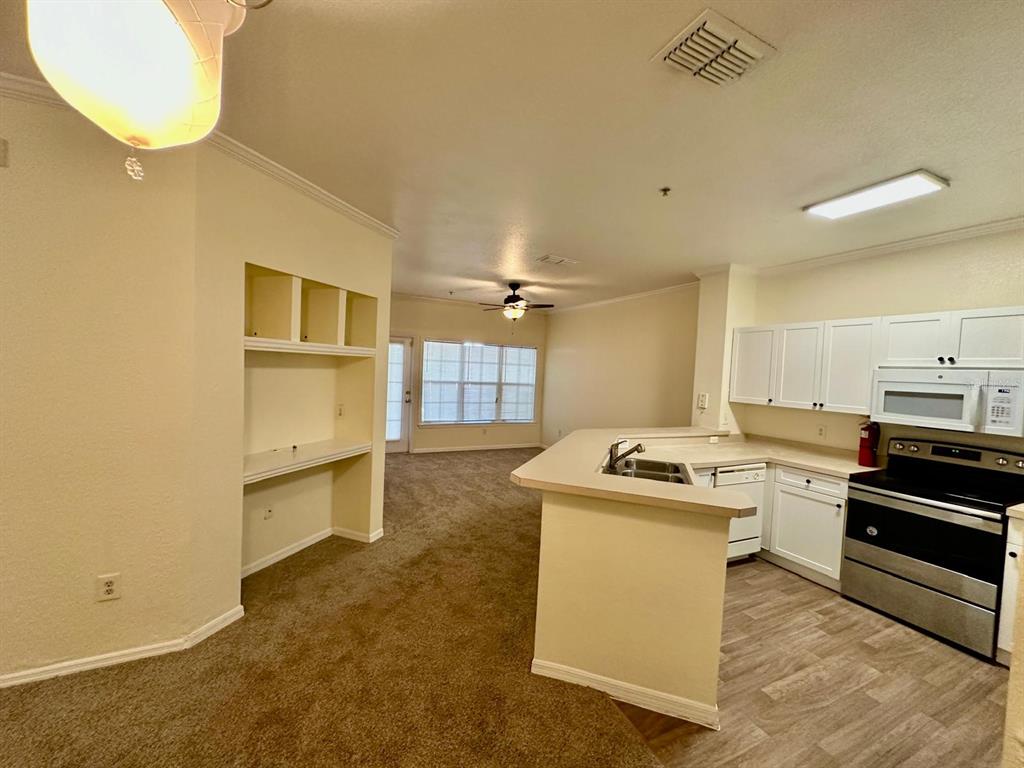 3561 Conroy Road, Unit 215 Orlando, FL 32839 - Photo 13 of 43 a kitchen with a stove and a refrigerator