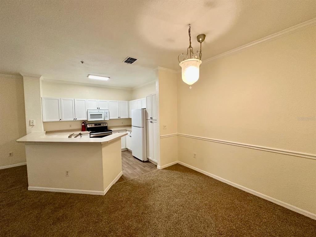 3561 Conroy Road, Unit 215 Orlando, FL 32839 - Photo 18 of 43 a kitchen with a sink cabinets and wooden floor