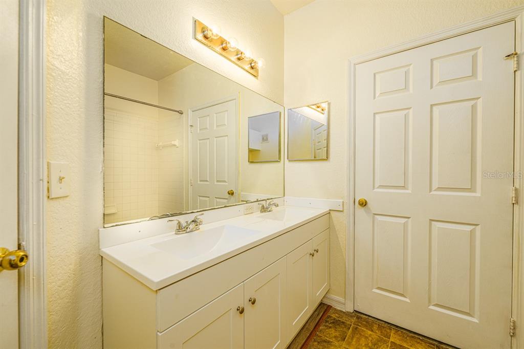 3561 Conroy Road, Unit 215 Orlando, FL 32839 - Photo 25 of 43 a bathroom with a sink and a mirror