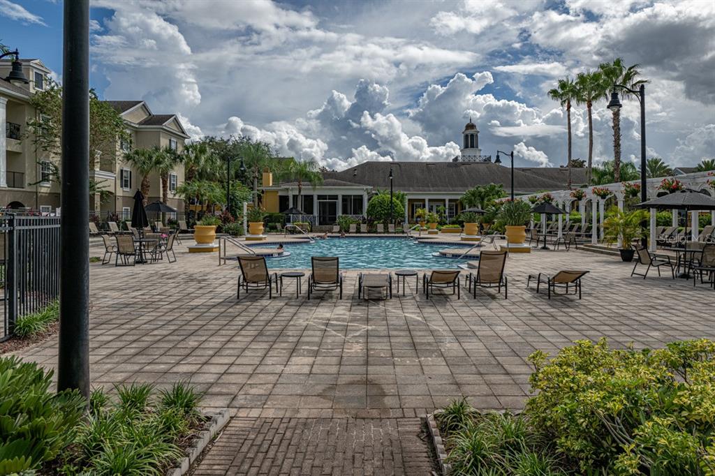 3561 Conroy Road, Unit 215 Orlando, FL 32839 - Photo 35 of 43 a view of a patio with dining table and chairs with plants