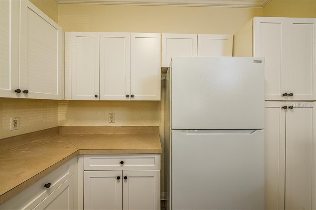 3561 Conroy Road, Unit 215 Orlando, FL 32839 - Photo 7 of 43 a white refrigerator freezer sitting in a kitchen