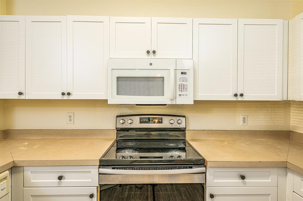 3561 Conroy Road, Unit 215 Orlando, FL 32839 - Photo 8 of 43 a stove top oven sitting inside of a kitchen