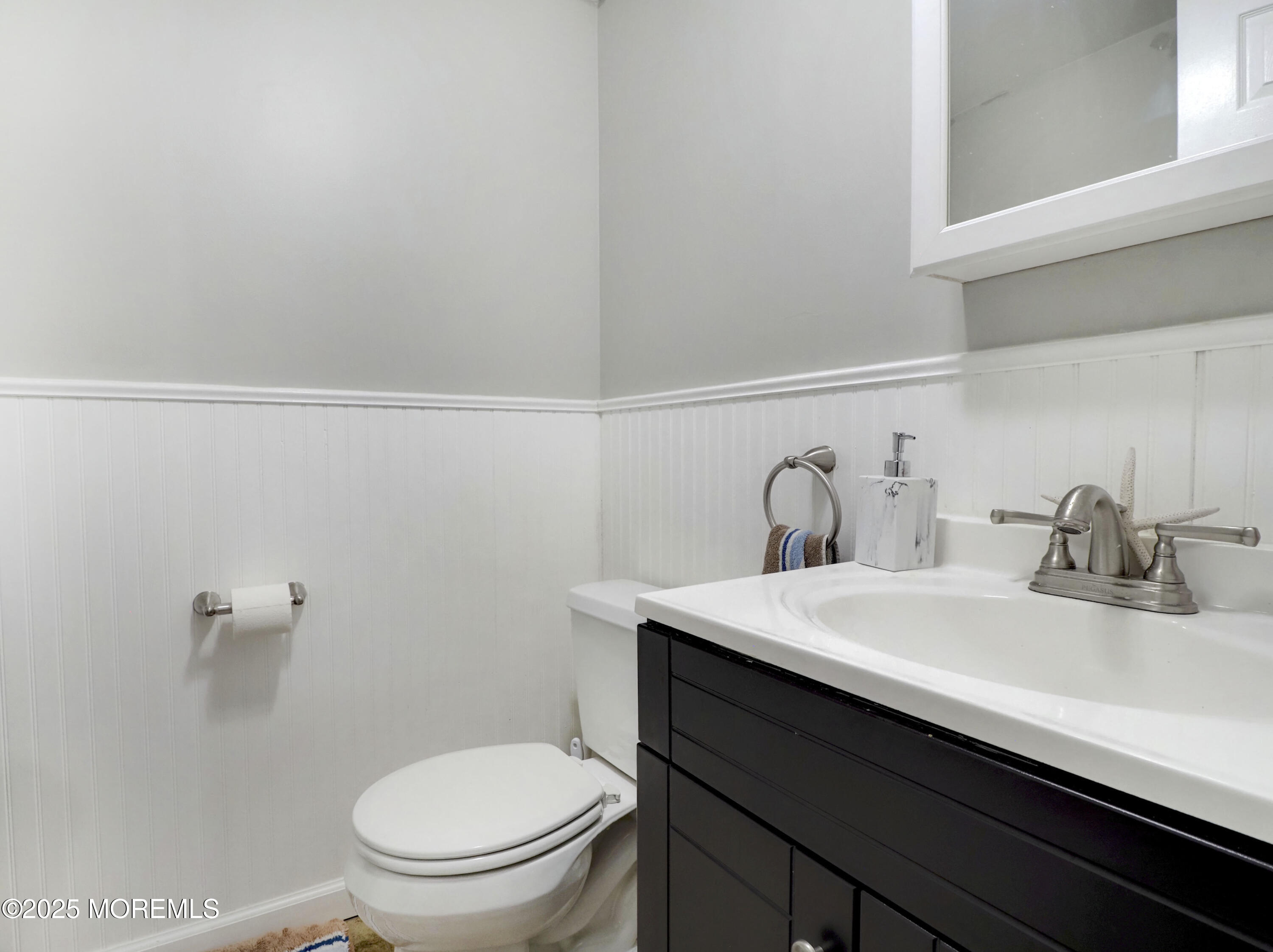82 Cliffwood Avenue West, Unit 25D Cliffwood, NJ 07721 - Photo 13 of 27 a bathroom with a sink a toilet and vanity