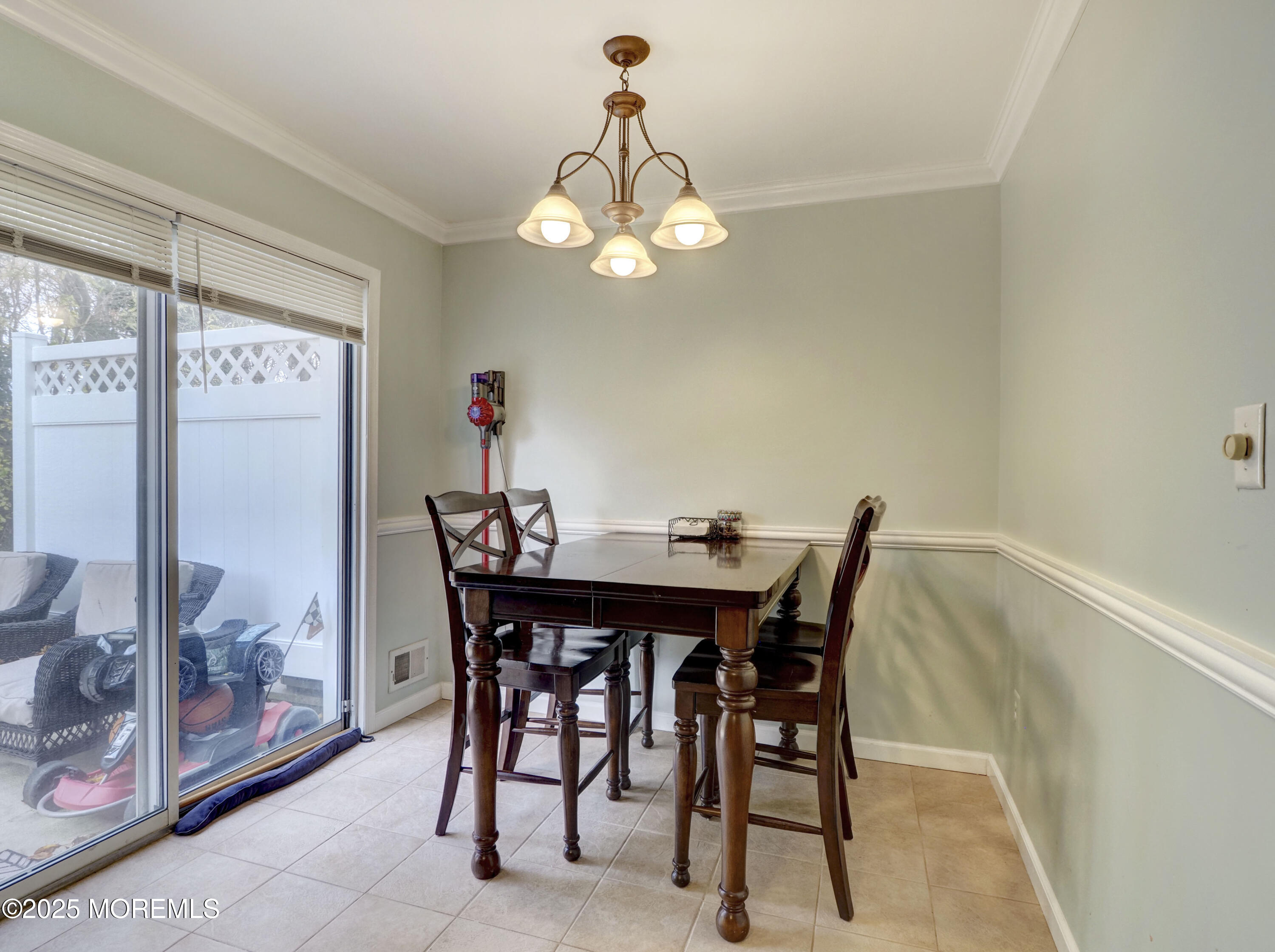 82 Cliffwood Avenue West, Unit 25D Cliffwood, NJ 07721 - Photo 15 of 27 a view of a dining room with furniture and a chandelier