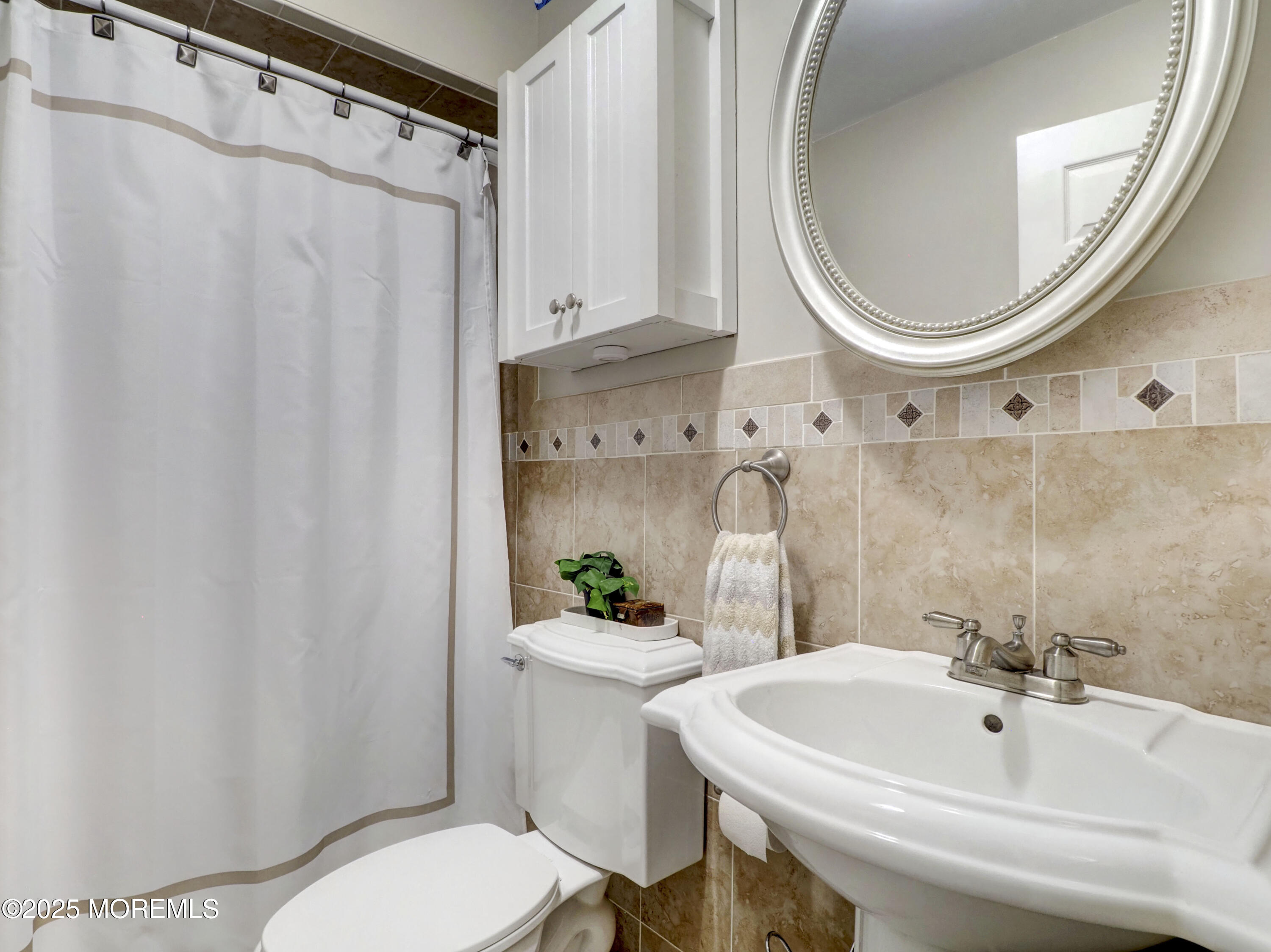 82 Cliffwood Avenue West, Unit 25D Cliffwood, NJ 07721 - Photo 19 of 27 a bathroom with a sink a toilet and a mirror