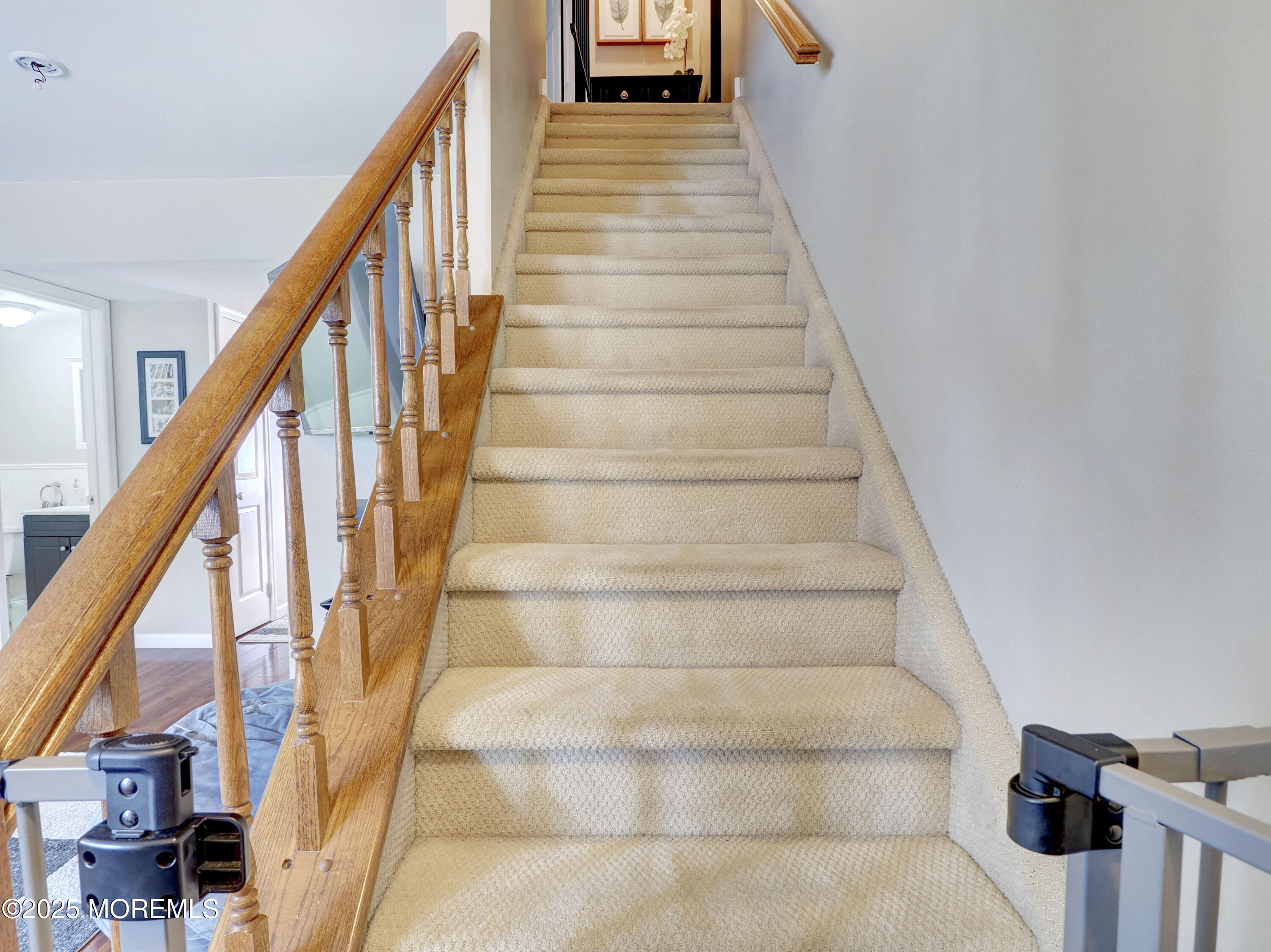 82 Cliffwood Avenue West, Unit 25D Cliffwood, NJ 07721 - Photo 23 of 27 a view of staircase with lots of frames on wall and wooden floor