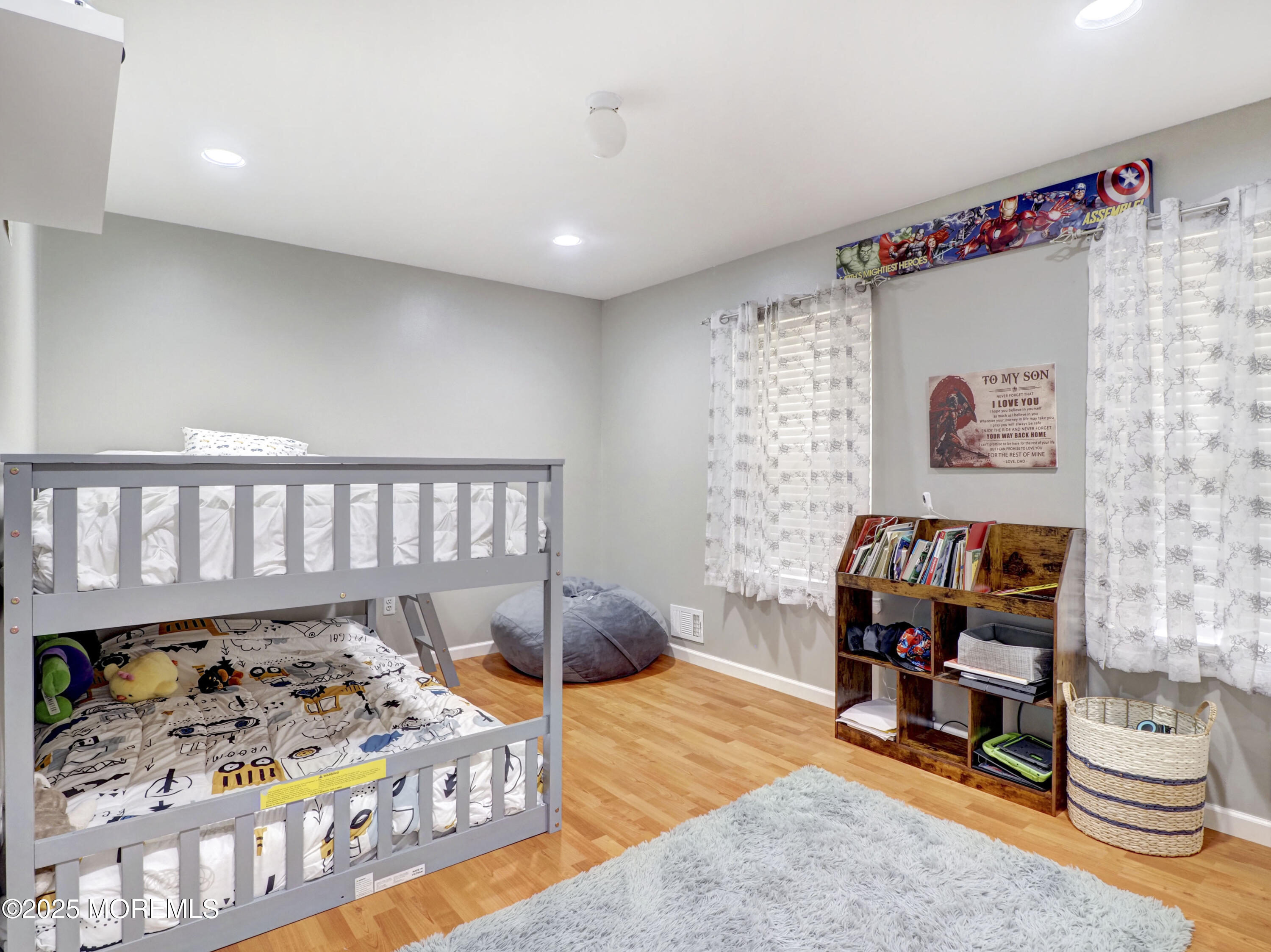 82 Cliffwood Avenue West, Unit 25D Cliffwood, NJ 07721 - Photo 25 of 27 a bedroom with furniture and a wooden floor