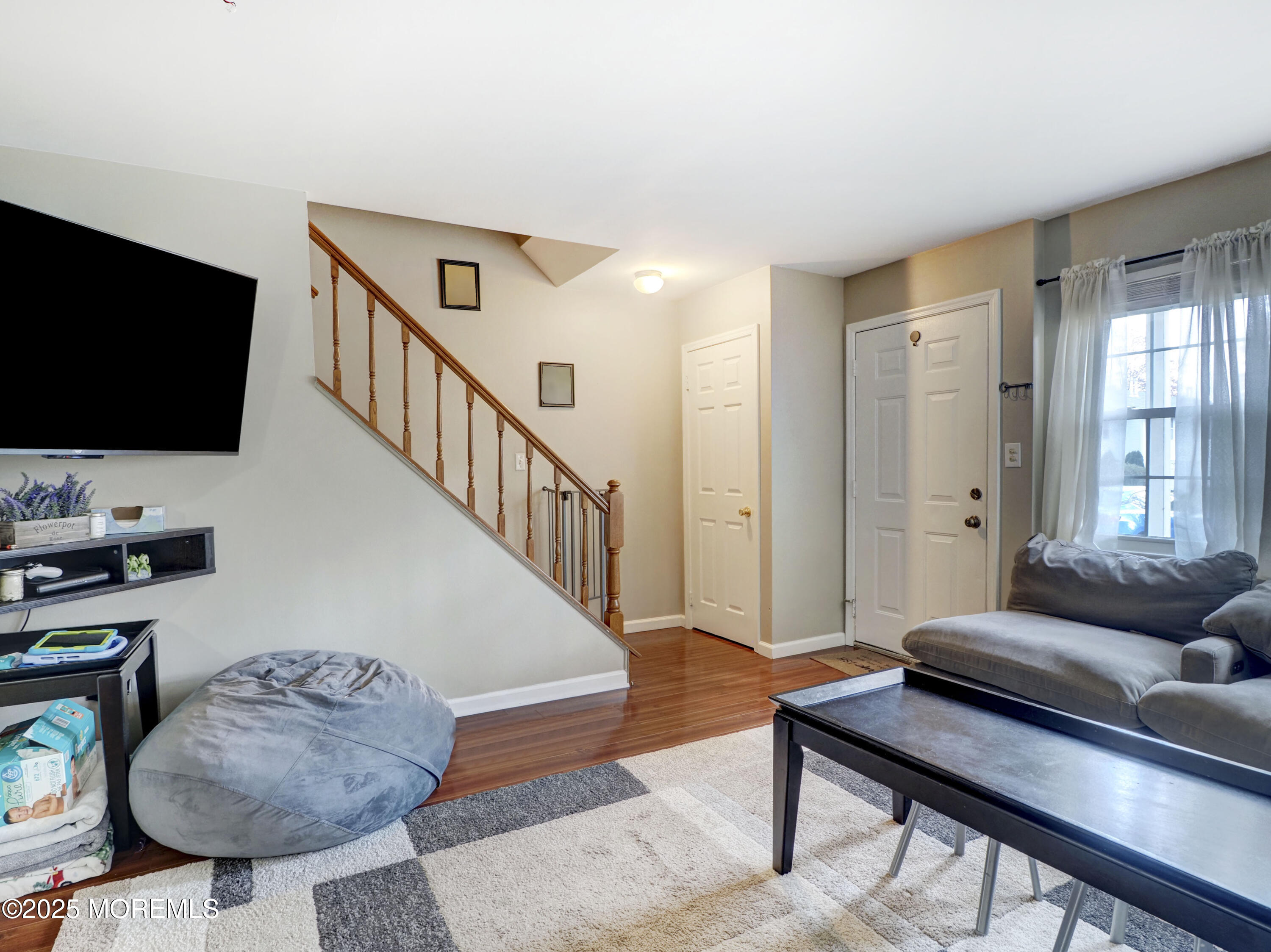 82 Cliffwood Avenue West, Unit 25D Cliffwood, NJ 07721 - Photo 10 of 27 a living room with furniture and a flat screen tv