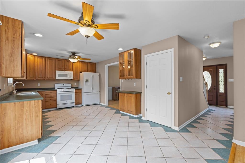 1552 Cathell Road Pittsburgh, PA 15236 - Photo 13 of 34 a kitchen with a refrigerator a sink and dishwasher