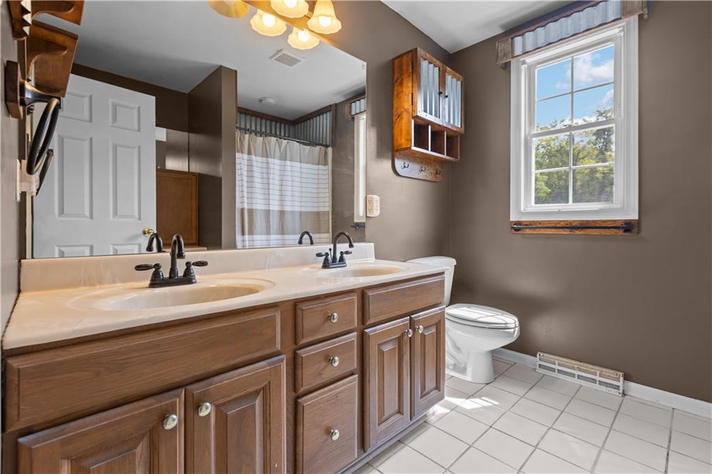 1552 Cathell Road Pittsburgh, PA 15236 - Photo 19 of 34 a bathroom with a double vanity sink mirror and toilet