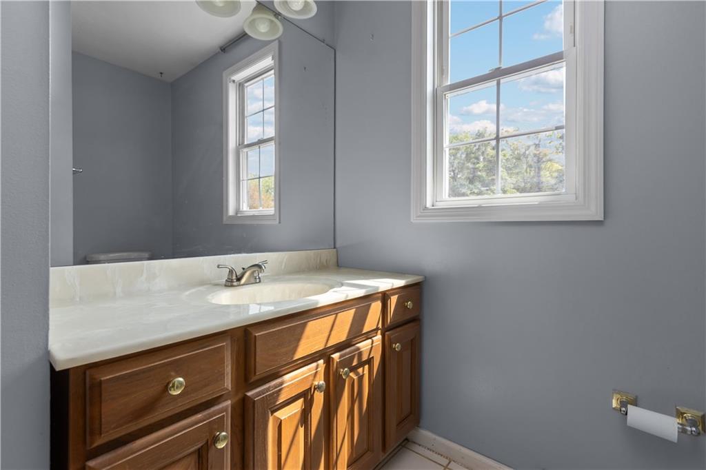 1552 Cathell Road Pittsburgh, PA 15236 - Photo 24 of 34 a bathroom with a sink a vanity and a window