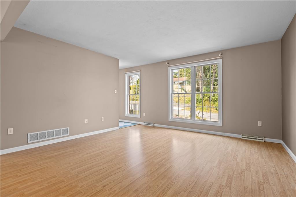 1552 Cathell Road Pittsburgh, PA 15236 - Photo 9 of 34 a view of an empty room with wooden floor and a window