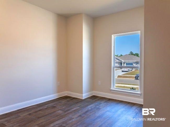 13791 Logan Place Foley, AL 36535 - Photo 21 of 25 Interior room featuring wood-finish flooring, neutral wall paint, and white baseboards