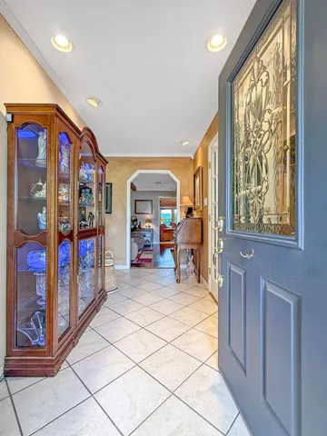 a living room with furniture and a dining table with kitchen appliances