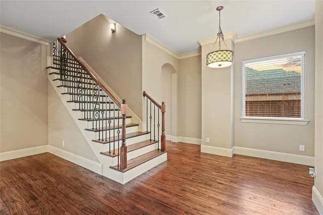 a view of entryway and hall with wooden floor