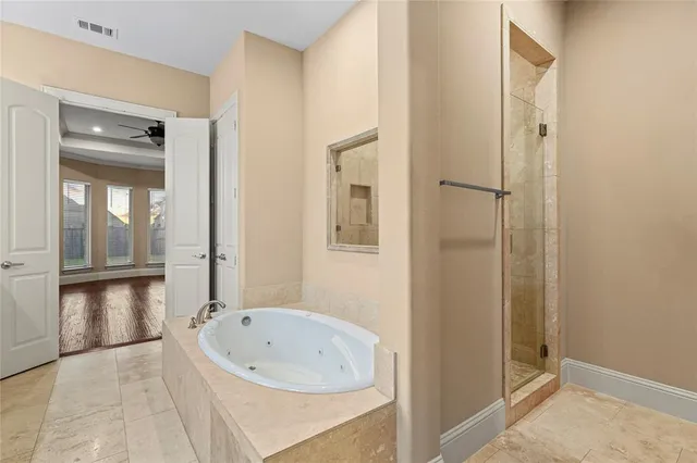 a bathroom with a bathtub and a shower