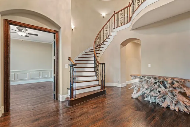 a view of entryway and hall with wooden floor