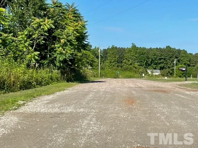 a view of a field with trees in the background