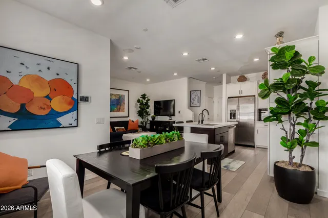 a view of a dining room with furniture and a potted plant