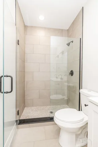 a bathroom with a toilet and a shower