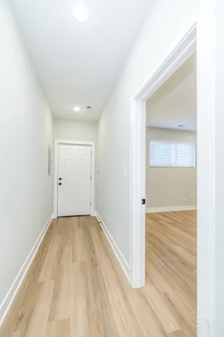 an empty room with wooden floor & closet