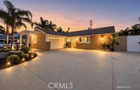 21104 Rosedell Drive Saugus, CA 91350 - Photo 3 of 33 Twilight front exterior with mature palms and expansive driveway