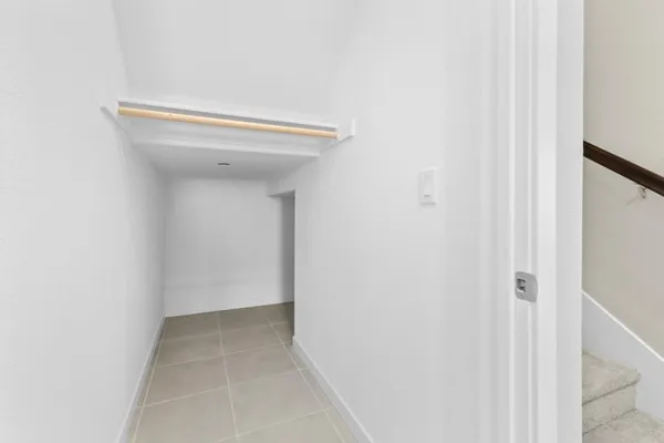 a kitchen with stainless steel appliances a sink a stove a refrigerator cabinets and a window