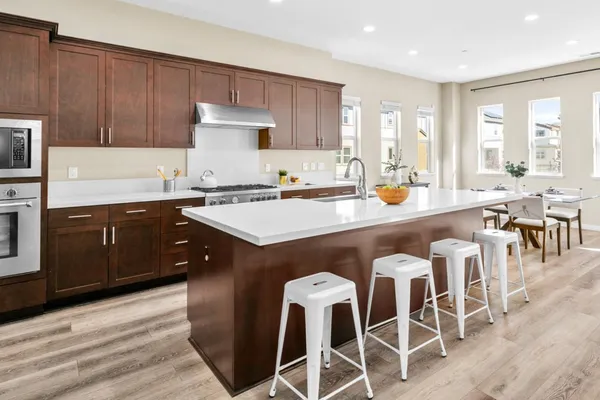 a large kitchen with a table and chairs