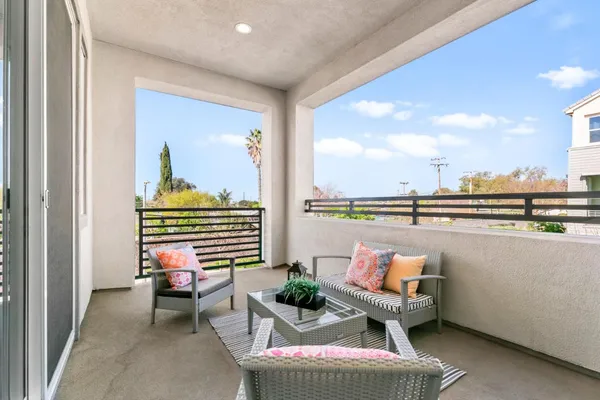 a view of a patio with plants and chairs