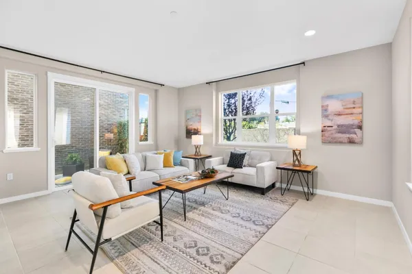 a living room with furniture and a potted plant