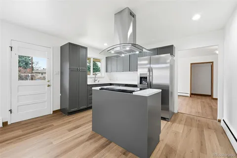 a kitchen with stainless steel appliances granite countertop a stove and a refrigerator