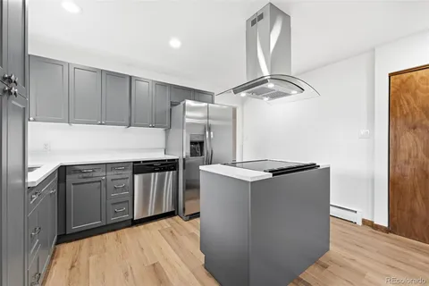 a kitchen with granite countertop a stove and a refrigerator