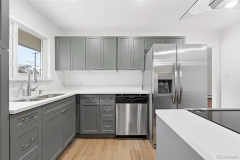 a kitchen with a sink stove and refrigerator