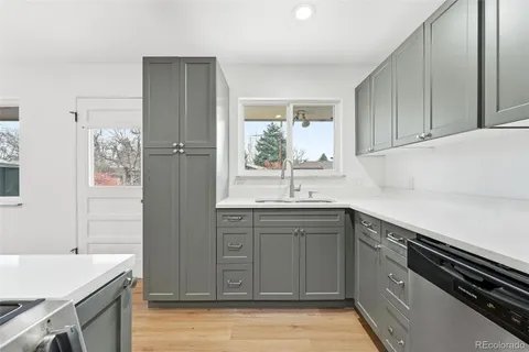 a kitchen with a sink appliances and cabinets