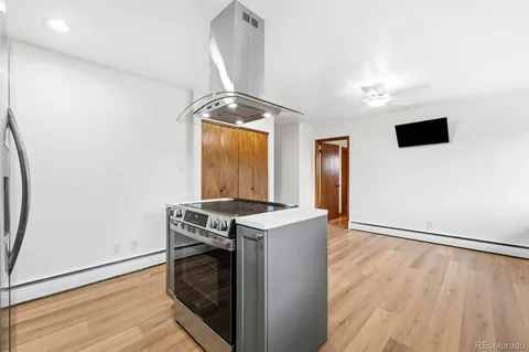 an entryway and a stove sitting inside of a room