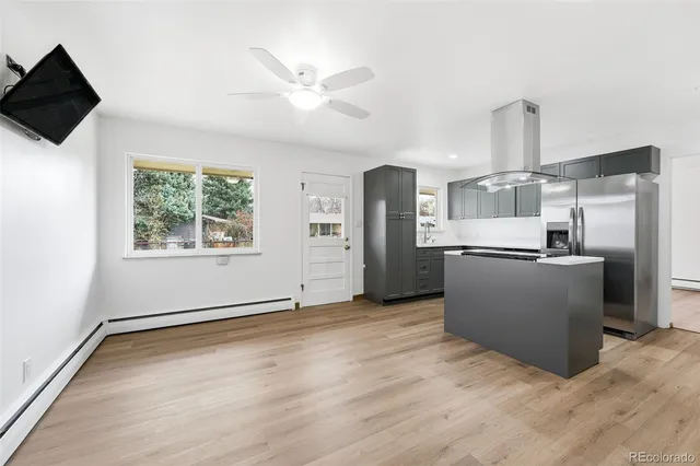 a view of a kitchen with a sink wooden cabinet and a refrigerator