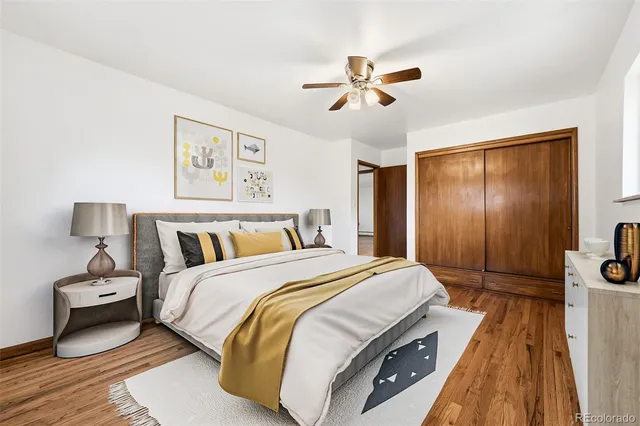 a spacious bedroom with a bed and a chandelier