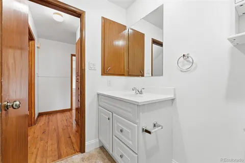 a bathroom with a sink a mirror and a shower