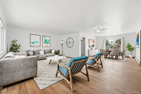 a living room with furniture wooden floor and a table