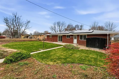 a view of a house with a backyard