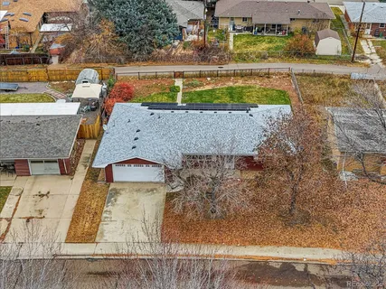 an aerial view of a house with a yard