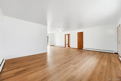 a view of an empty room and wooden floor