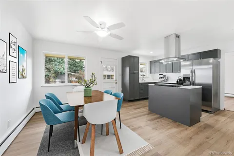 a living room with stainless steel appliances kitchen island granite countertop furniture and a kitchen view