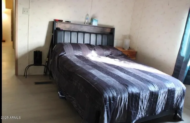 a bed sitting in a bedroom next to a window