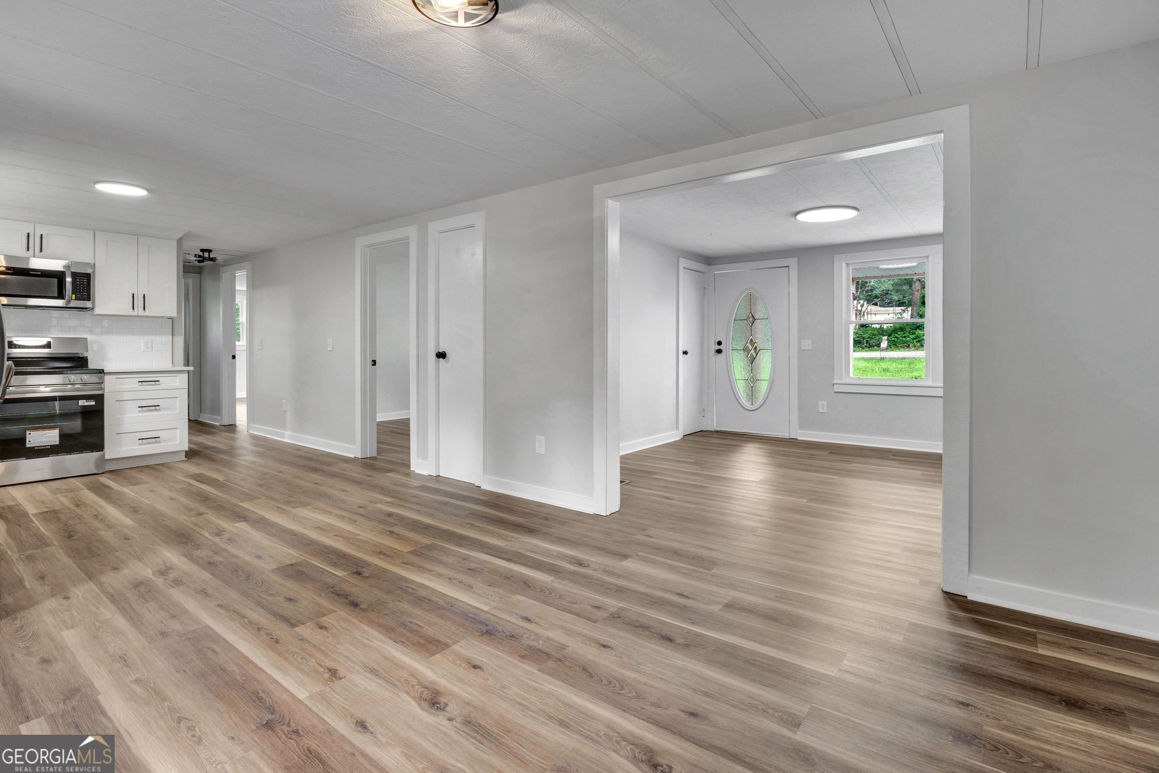455 Cindy Street Jackson, GA 30233 - Photo 8 of 25 a view of a kitchen with wooden floor and a window